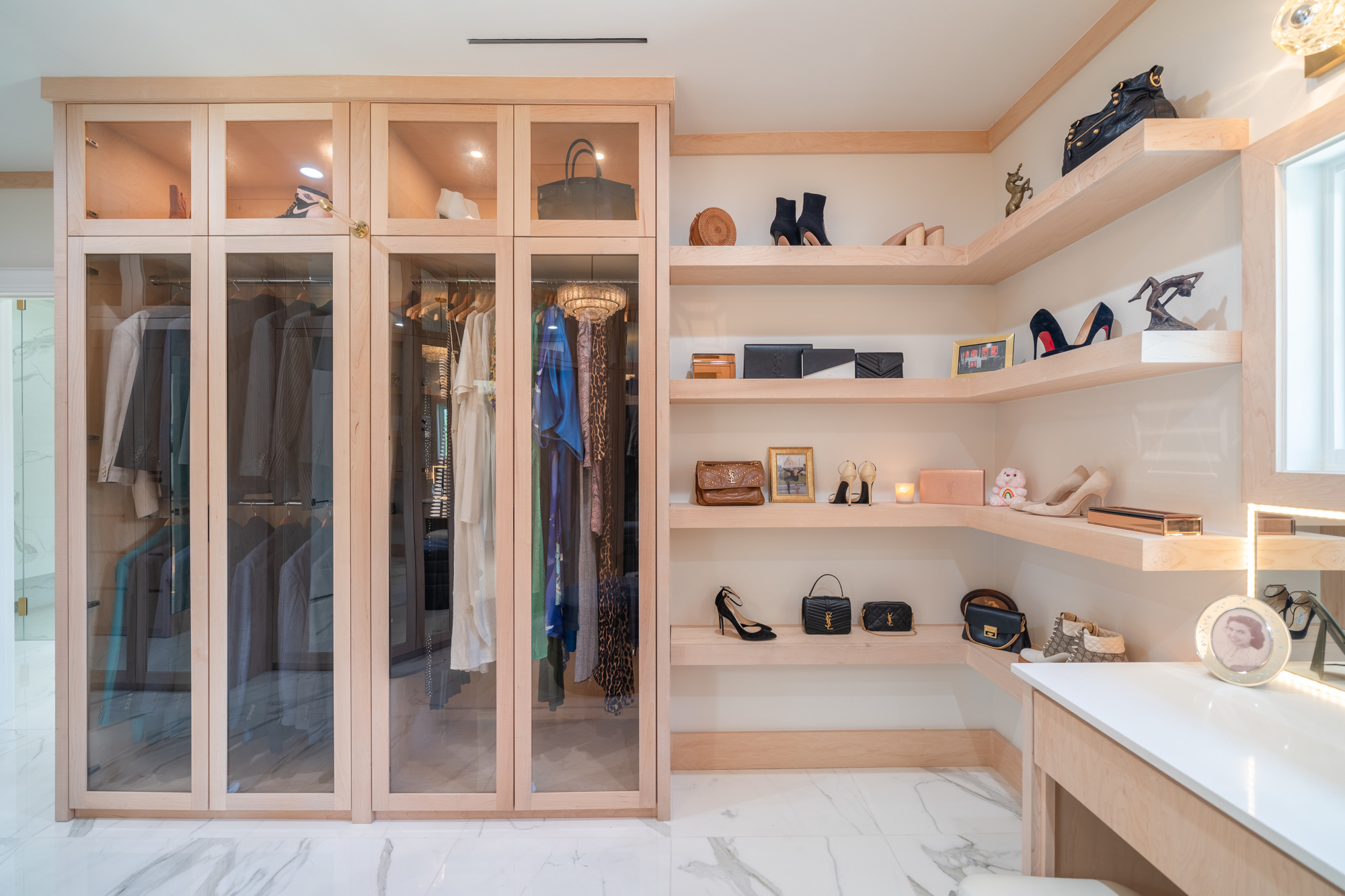 Custom pale-wood wardrobe with illuminated display shelves