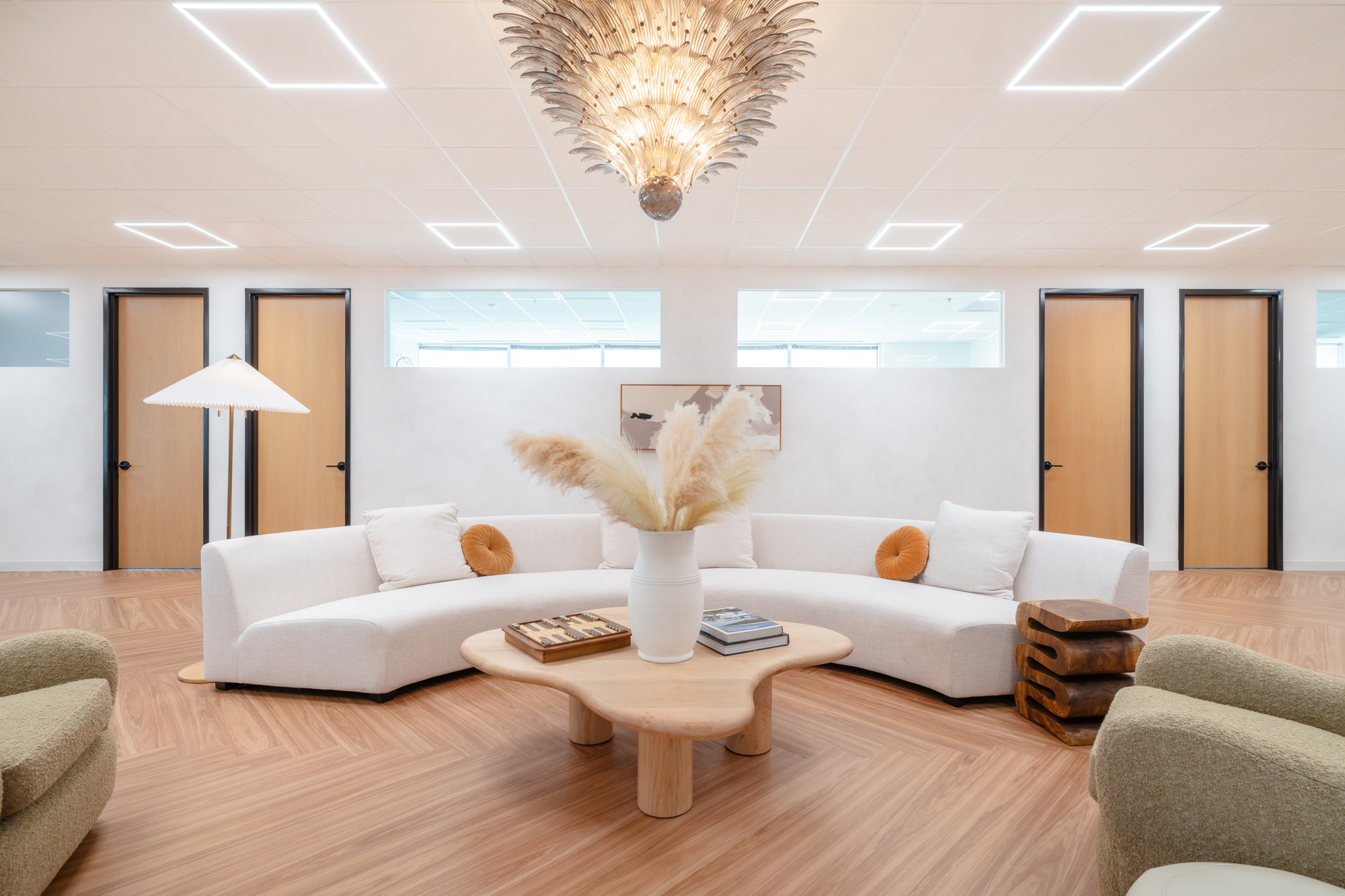 Inviting workplace lounge with sculptural seating and warm wood